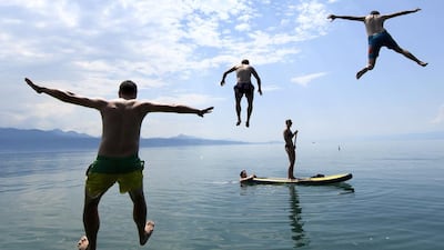 People enjoy the sunny weather on Lake Geneva, in Lutry, south-west Switzerland. Laurent Gilleron / EPA