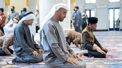 Sheikh Mansour bin Zayed, Sheikh Mohamed and Mr Widodo pray during the inauguration of the Sheikh Zayed Grand Mosque.