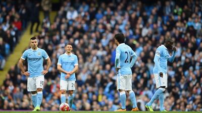 Sergio Aguero, Martin Demichelis, David Silva and Yaya Toure of Manchester City look dejected against Manchester United. (Photo by Laurence Griffiths/Getty Images)