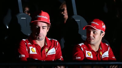 Ferrari's Fernando Alonso and Felipe Massa get ready to try out a ride at Ferrari World. Marwan Naamani/AFP