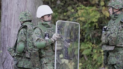 Japanese troops practise setting up a bear trap in the woodland town of Kazuno. Reuters