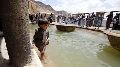 A Yemeni child cools off in a fountain at a historical site on the outskirts of Sanaa, Yemen, during Eid al-Fitr. EPA