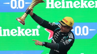 Mercedes' Kimi Antonelli celebrates with the trophy on the podium after winning the Chinese Grand Prix. Reuters