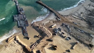 Lorries carry humanitarian supplies into the enclave through the pier, in May 2024. AFP