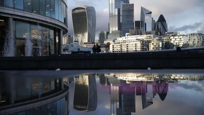 Office buildings of the City of London are reflected in a puddle. The IHS Markit/CIPS services Purchasing Managers’ Index for the UK fell to a four month low of 51.4 in October from 56.1 in September. AFP