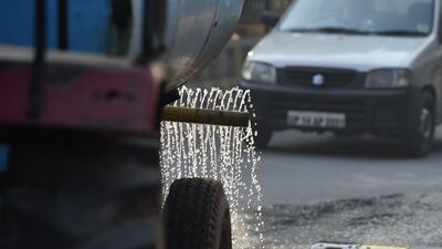 A Ghaziabad Municipal Corporation tanker sprinkles water along a road to reduce airborne dust particles as part of smog-reducing measures in Ghaziabad on the outskirts on New Delhi. Air pollution in the Indian capital soars during the winter months as cooler air traps harmful particles from crop fires, exhaust fumes, construction dust and industrial emissions. The World Health Organisation (WHO) in May 2018 listed 14 Indian cities, including Delhi, in the world's top 15 with the dirtiest air. AFP