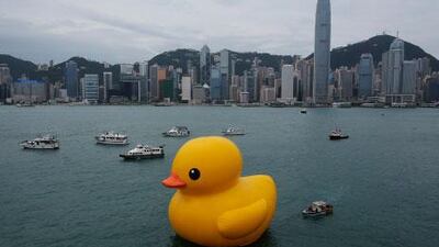 A giant Rubber Duck created by Dutch artist Florentijn Hofman is towed along Hong Kong's Victoria Habour.