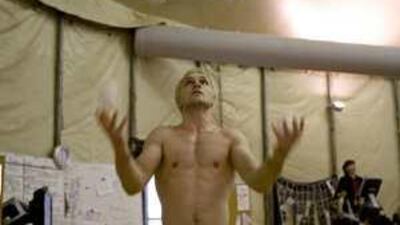 Denys Tolstov practices his hand balancing act during rehearsal before a performance of Alegria in Dubai.