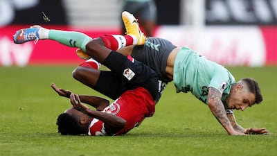 Kyle Walker-Peters is fouled by Lucas Digne in the challenge that brought a red card. EPA