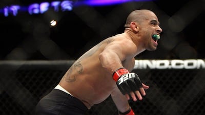 Renan Barao celebrates after beating Urijah Faber to retain his title belt on Saturday night. Tim Larsen / AP