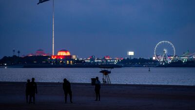 The UAE Flag area on the Corniche in Abu Dhabi lights up in red to celebrate the success of the Hope probe going into orbit around Mars. Victor Besa / The National
