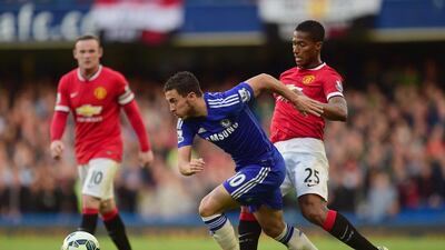 Eden Hazard, centre, of Chelsea and Luis Antonio Valencia of Manchester United fight for the ball during their Premier League match at Stamford Bridge on April 18, 2015 in London, England. Jamie McDonald/Getty Images