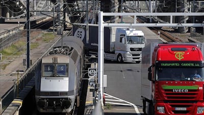 Trucks are unloaded from a Eurotunnel freight train after crossing the Channel Tunnel in Coquelles. The tunnel project cost £4.65 billion to build, 80 per cent more than expected. Christian Hartmann / Reuters