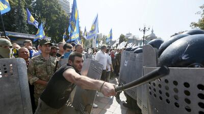 A grenade exploded outside Ukraine’s parliament during a nationalist protest against a vote to give greater powers to separatist regions in the east, killing one police officer, the interior ministry said. Valentyn Ogirenko / Reuters