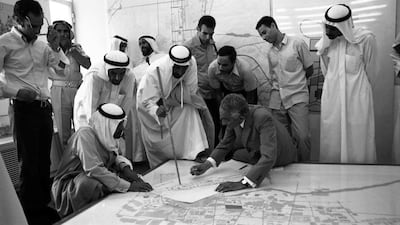 Sheikh Zayed examines a plan of Abu Dhabi with the architect Dr Abdul Rahman Makhlouf at the Ministry of Municipalities and Agriculture in the 1970s.