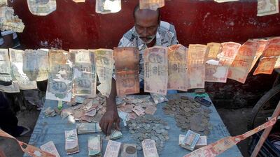 A roadside currency exchange vendor sorts Indian currency notes at his stall in Agartala. Jayanta Dey / Reuters