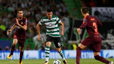 Sporting’s Rodrigo Battaglia takes on Barcelona’s Sergio Busquets. Pedro Nunes / Reuters