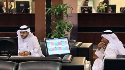 Emirati investors follow the stock market developments on their monitor screens at the Dubai Financial Market. Would investor confidence be improved if bank bosses adopted more transparency? EPA/ALI HAIDER