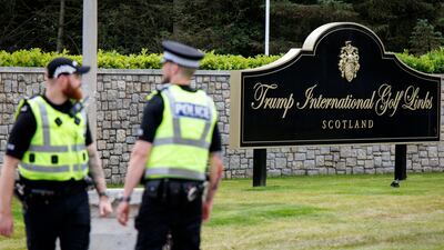 Police officers guard the entrance to the Trump International Golf Links. EPA