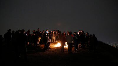 A crowd gathers round a bonfire for Charshanbeh Suri, in Tehran. The festival is also marked by fortune telling and smashing pots for good luck. EPA