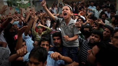 A young Kashmiri boy shouts slogans during a protest on the outskirts of Srinagar