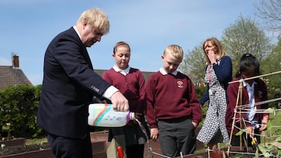Boris Johnson Boris Johnson waters the vegetable garden. Getty Images