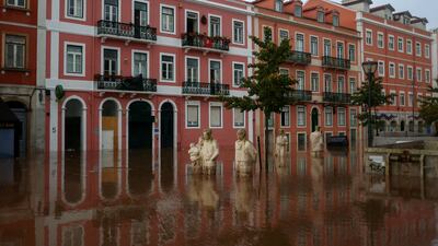 Submerged statues on a flooded street in Alges, Portugal. Reuters