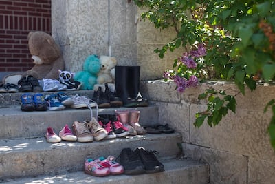 Children's shoes have been placed on the front steps the former Muskowekwan Indian Residential School, one of the last to close its doors in Canada. AP
