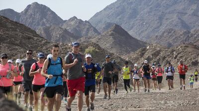 A group of trail runners set a fast pace as they wind their way through the rocky terrain of Showka Hill. Antonie Robertson / The National