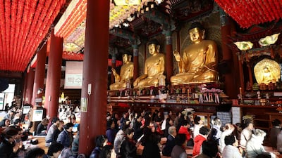 South Koreans pray at a temple in Seoul. Getty Images