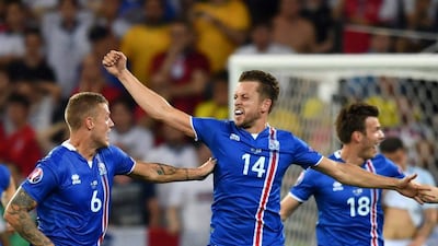 Iceland's defender Ragnar Sigurdsson and Iceland's defender Kari Arnason and Iceland's midfielder Theodor Bjarnason celebrate their team's win after the Euro 2016 round of 16 football match between England and Iceland at the Allianz Riviera stadium in Nice on June 27, 2016. Iceland won the match 1-2. (AFP/BERTRAND LANGLOIS)