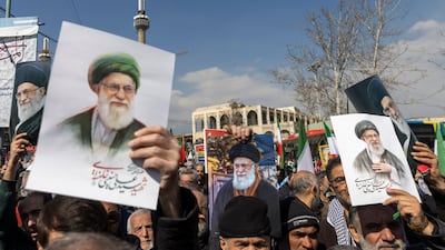 Iranians hold images of Ayatollah Ali Khamenei as they take part in a demonstration against the US and Israel in Tehran. Getty Images