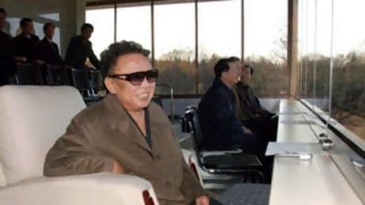 In this undated photo North Korean leader Kim Jong Il, wearing glasses, watches a soccer game between teams of the (north) Korean People's Army. The news service did not say the date nor place the North Korean leader watched the game.
