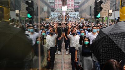 Masked protesters march in the street. EPA