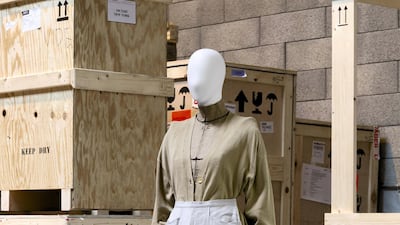 Martin Margiela, spring / summer 1997: beige canvas jacket with print, with a light grey denim half-skirt with strap, and a beige knit cardigan with shoulder pads. Photo: Sotheby's