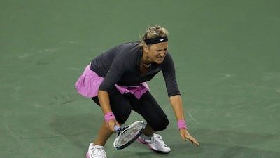 Victoria Azarenka of Belarus winces in pain after returning a shot to Lauren Davis during her loss at the BNP Paribas Open at Indian Wells. Jeff Gross / Getty Images / AFP / March 7, 2014