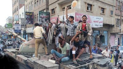 Resistance fighters loyal to the government of Yemeni president Abdrabu Mansur Hadi ride atop a tank they seized from Houthi militiamen in the city of Taez on August 17, 2015. Reuters