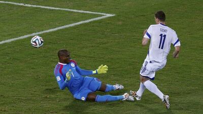 Edin Dzeko of Bosnia chips the ball past Nigeria goalkeeper Vincent Enyeama for a goal that was disallowed for offsides on Saturday at the 2014 World Cup in Cuiaba, Brazil. Suhaib Salem / Reuters
