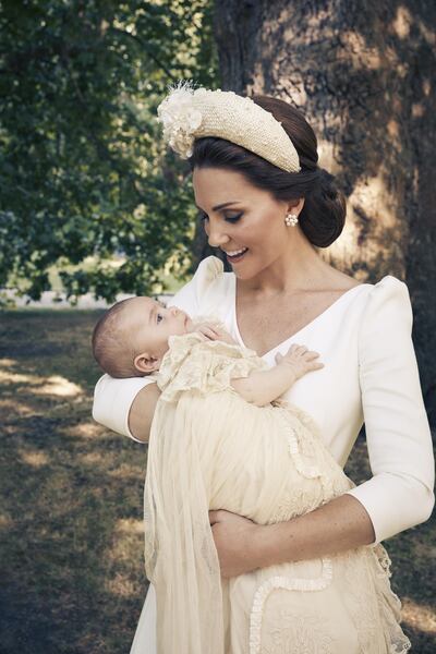The Duchess of Sussex poses in a portrait of Prince Louis following his christening at Clarence House, London in July 2018. Prince Louis wore a the replica of Queen Victoria had made in 1941. Matt Holyoak / Camera Press