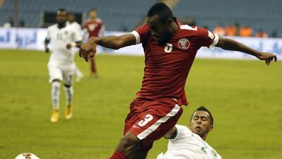 Saudi Arabia’s Saeed al-Mowalad (R) challenges Qatar’s Karim Hassan for the ball during the opening match of the 22nd Gulf Cup football tournament at the King Fahd Stadium in Riyadh on November 13, 2014. Eight nations are taking part in the games including Oman, UAE, Kuwait, Yemen, Bahrain, Iraq, Saudi Arabia and Qatar. AFP PHOTO/KARIM SAHIB