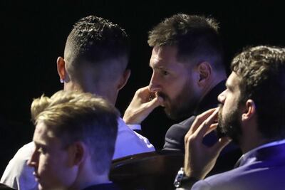 Argentine forward Lionel Messi, right, and Cristiano Ronaldo, back to camera, sat together at Thursday's Uefa Awards. AFP
