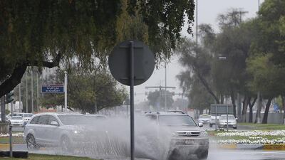 Motorists drive through a flooded street in Abu Dhabi. Ravindranath K / The National