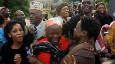 Kenyan family members of Barack Obama, including his step-grandmother Sarah Obama, centre in red top, celebrate after his victory, in Kogelo village.