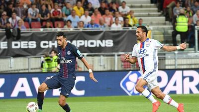 Paris Saint-Germain’s Argentinian midfielder Javier Pastore (L) scores the first goal next to Lyon’s French defender Jeremy Morel (R) during the Trophee des Champions ‘super cup’ match between PSG and Lyon in Klagenfurt, Austria, on August 6, 2016. Boris Horvat / AFP