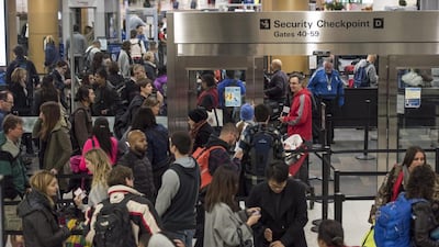 Travelers go through the security checkpoint at San Francisco International Airport (SFO) in San Francisco, California, U.S., on Thursday, Dec. 24, 2015. U.S. travelers over the year-end holiday season will surge to a record 100.5 million as cheap fuel makes trips more affordable. David Paul Morris / Bloomberg