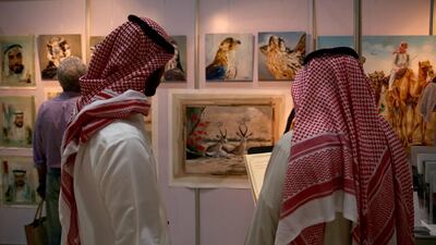 Visitors look at wildlife art work. Warren Little / Getty Images