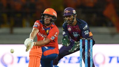 Rising Pune Supergiants captain MS Dhoni, right, looks on as Gujarat Lions’ Aaron Finch plays a shot. Indranil Mukerjee / AFP