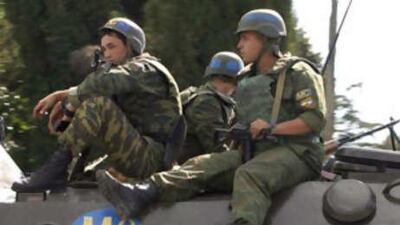 Russian troops move along a road outside the Georgian town of Zugdidi on Sept 13 2008. Russian troops withdrew from the region around Georgia's Black Sea port of Poti within a Sept 15 deadline set for the first phase of a pullback brokered by France.