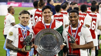 From left, Lisandro Martinez, Edson Alvarez, and Jurrien Timber of Ajax with the Dutch league trophy. EPA