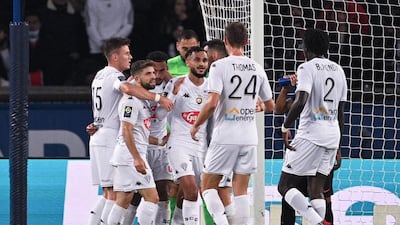 Angers midfielder Angelo Fulgini (C) celebrates with teammates after giving his side the lead. AFP